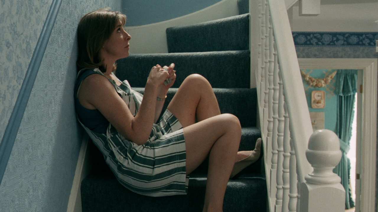 a woman sitting on the stairs looking up